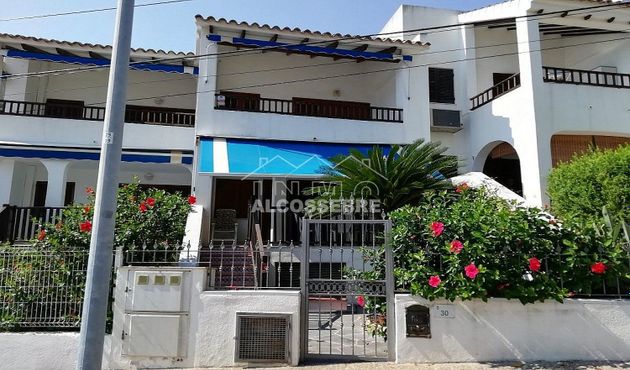 Foto 1 de Casa adosada en venta en calle L'atall Zona Ribamar de 3 habitaciones con terraza y piscina