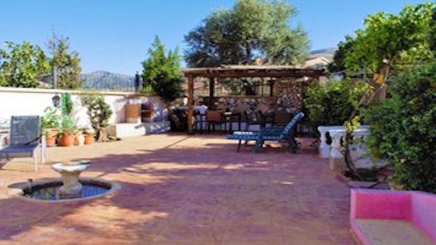 Foto 1 de Venta de casa adosada en Arenas del Rey de 7 habitaciones con terraza y piscina