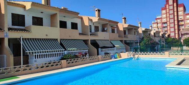 Foto 2 de Venta de casa adosada en El Perellonet de 4 habitaciones con terraza y piscina