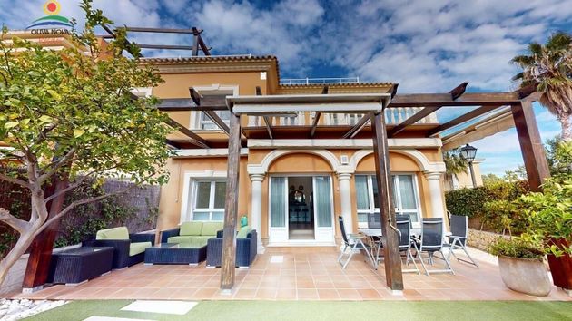 Foto 1 de Casa adossada en venda a Oliva Nova de 3 habitacions amb terrassa i piscina
