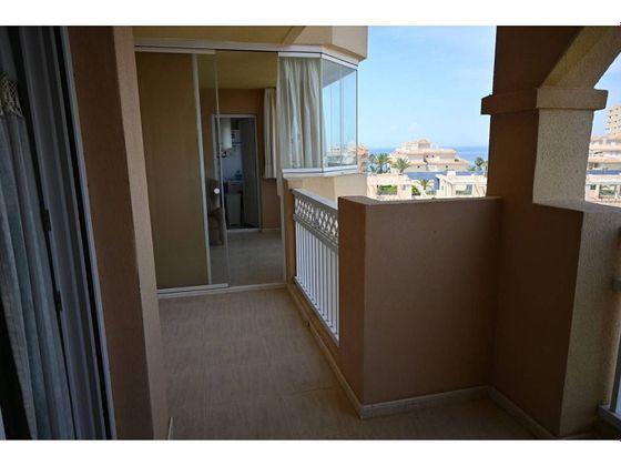 Foto 1 de Venta de piso en urbanización Marinesco II la Manga del Mar Menor de 2 habitaciones con terraza y piscina