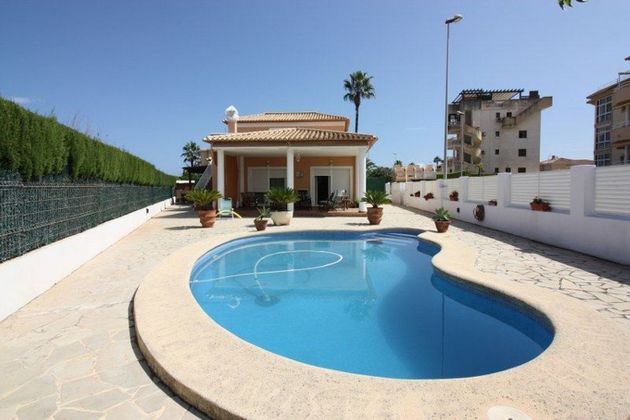 Foto 1 de Venta de casa en Oliva Nova de 3 habitaciones con terraza y piscina