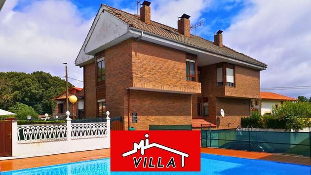 Foto 1 de Casa adosada en venta en Bárcena de Cicero de 4 habitaciones con terraza y piscina