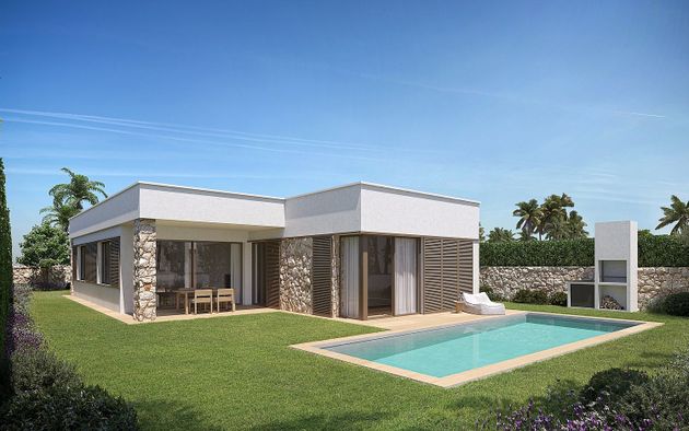 Foto 1 de Casa nova en venda a Mercadal (Es) de 4 habitacions amb piscina i jardí